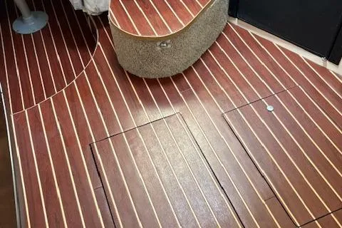 Slide: The Image of 1995 Sea Ray 370 Sundancer interior with polished wooden flooring. - 14