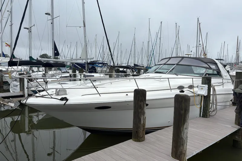 Slide: The Image of 1995 Sea Ray 370 Sundancer docked at marina with sailboats in background. - 3