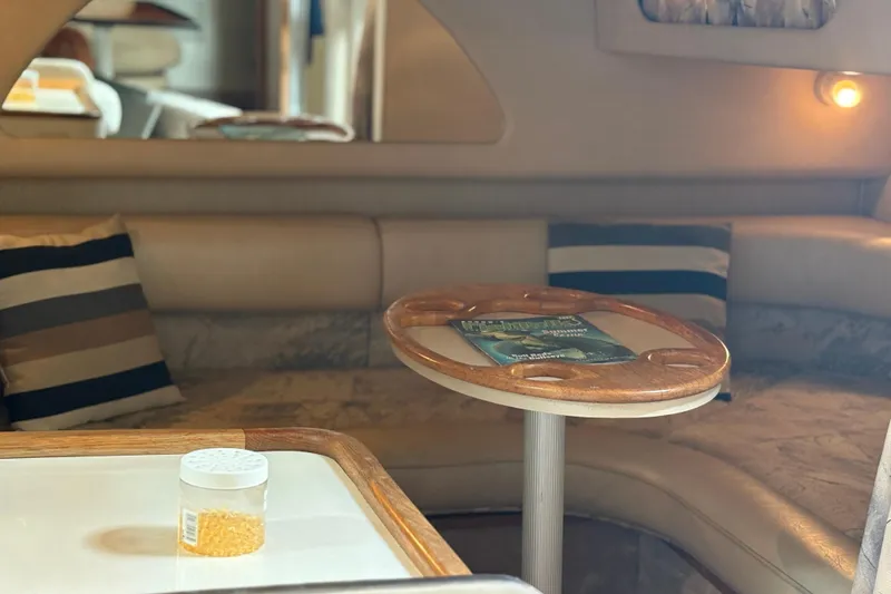 Slide: The Image of Interior of 1995 Sea Ray 370 Sundancer with cozy seating and wooden table. - 5