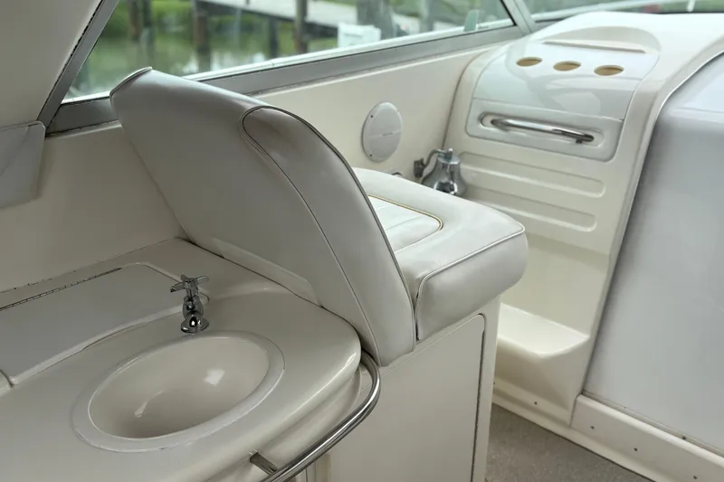 Slide: The Image of Interior of a 1995 Sea Ray 370 Sundancer boat with sink and seating area. - 8