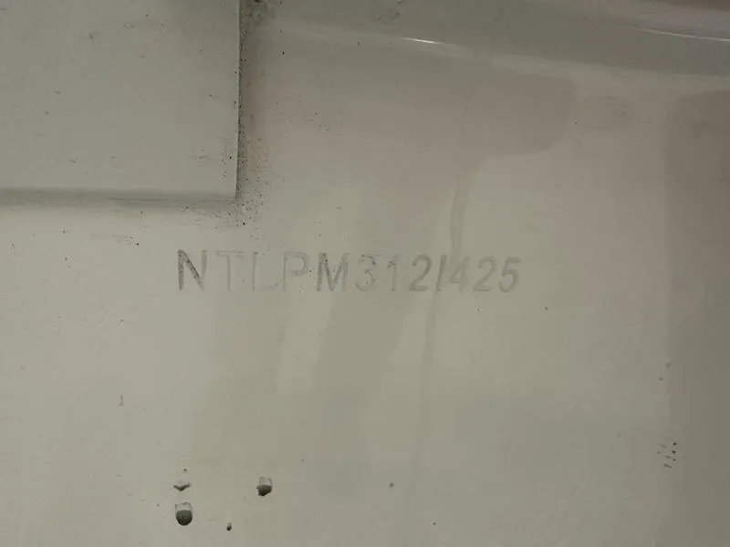 Slide: The Image of 2025 Grady-White Freedom 215 boat interior with white cushioned seating. - 10