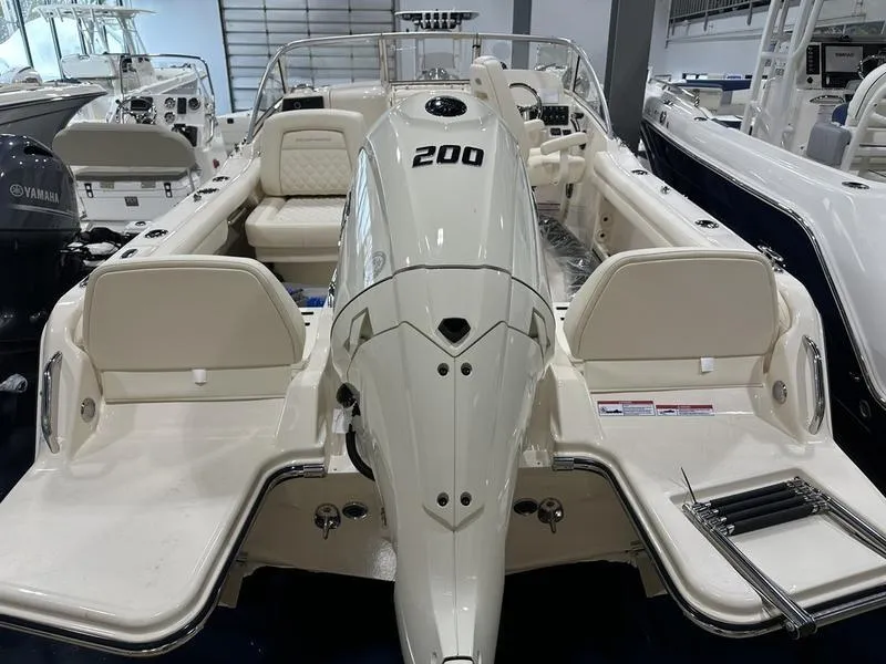 Slide: The Image of 2025 Grady-White Freedom 215 boat dashboard with steering wheel and electronic controls. - 11