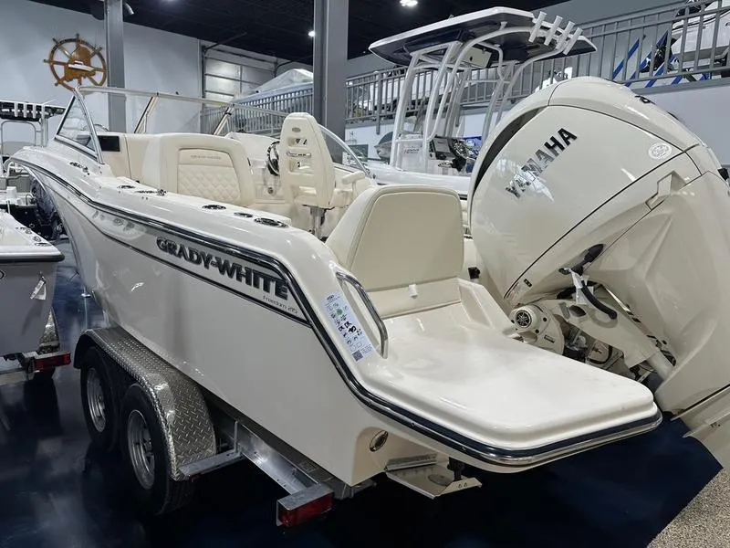 Slide: The Image of 2025 Grady-White Freedom 215 boat interior with portable toilet and wooden flooring. - 13