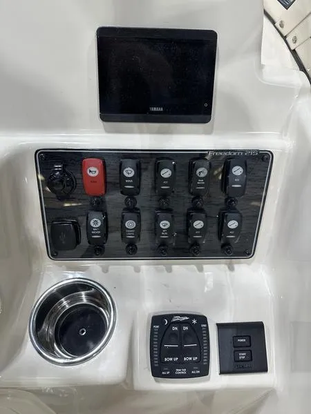 Slide: The Image of 2025 Grady-White Freedom 215 boat docked, featuring Yamaha outboard motor. - 2