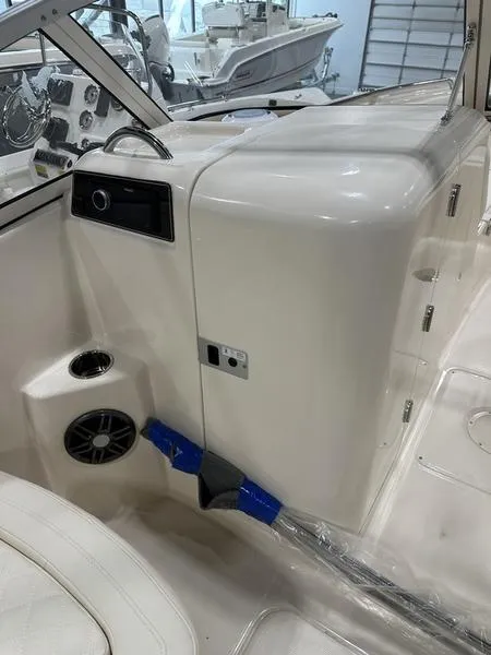 Slide: The Image of 2025 Grady-White Freedom 215 boat docked in a marina. - 4