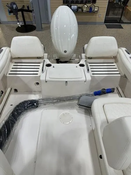 Slide: The Image of 2025 Grady-White Freedom 215 boat interior with white seating and speakers. - 9