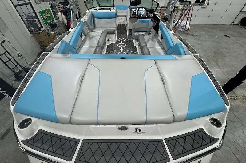 Slide: The Image of 2019 MasterCraft NXT22 boat interior with blue and gray seating, modern dashboard, and spacious layout. - 10