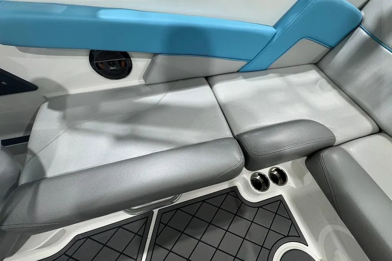 Slide: The Image of 2019 MasterCraft NXT22 boat interior with blue and gray seating, diamond-patterned flooring. - 14