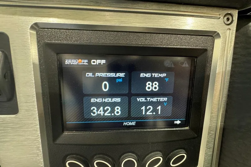 Slide: The Image of 2019 MasterCraft NXT22 boat interior with blue and gray seating, featuring speakers and cup holders. - 20