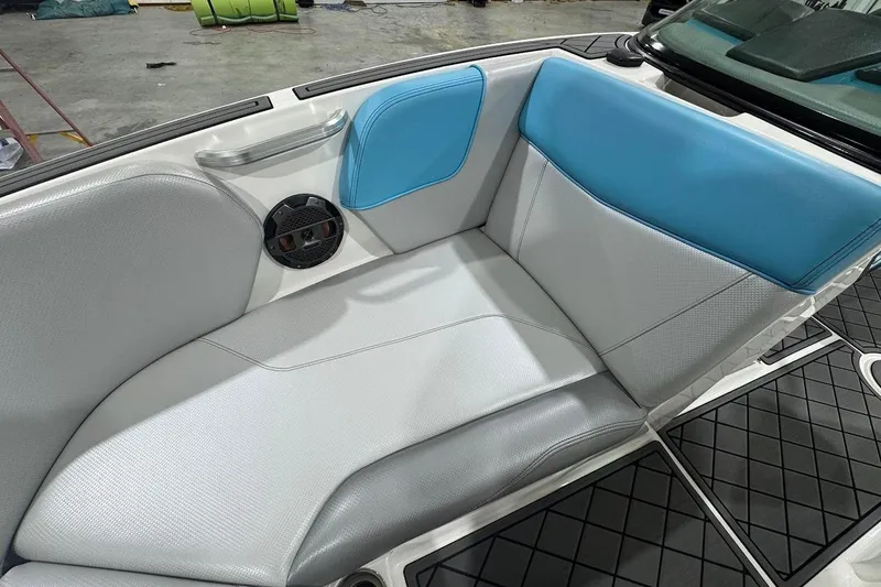 Slide: The Image of 2019 MasterCraft NXT22 boat with a sleek wakeboard rack in a showroom setting. - 23