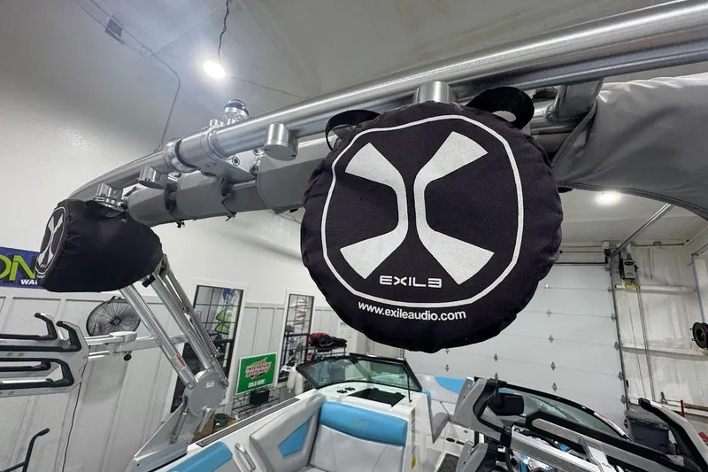 Slide: The Image of 2019 MasterCraft NXT22 boat with Exile audio speaker in a garage setting. - 25