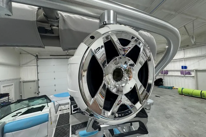 Slide: The Image of 2019 MasterCraft NXT22 boat detail in a spacious garage with equipment. - 26