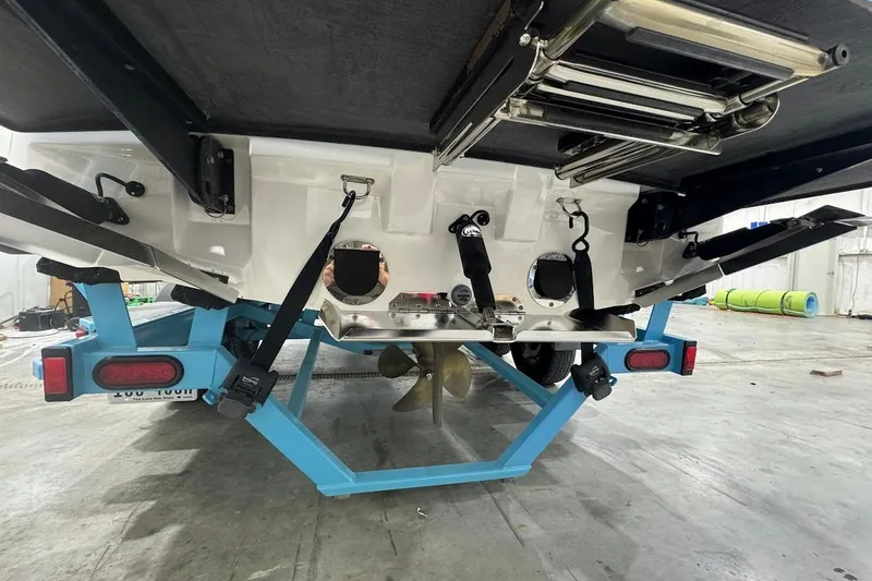 Slide: The Image of Rear view of a 2019 MasterCraft NXT22 boat on a blue trailer in a garage. - 5
