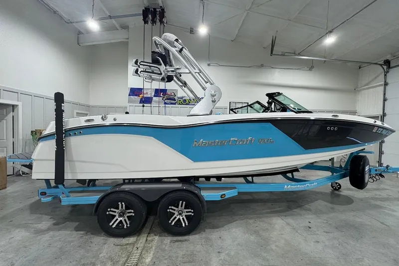 Slide: The Image of 2019 MasterCraft NXT22 boat on trailer in indoor storage facility. - 7