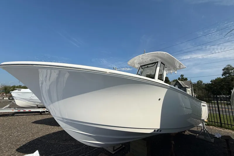 The Image of 2026 Sportsman Heritage 231 Center Console boat under clear blue sky. - 0