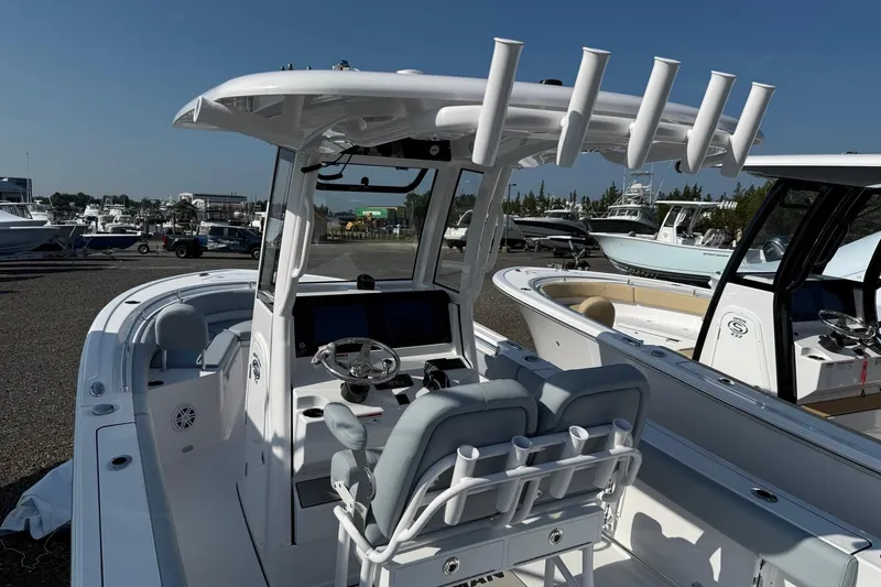 Slide: The Image of 2026 Sportsman Heritage 231 Center Console boat with modern helm and seating. - 2