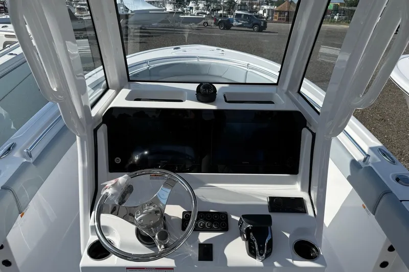 Slide: The Image of 2026 Sportsman Heritage 231 Center Console boat dashboard with steering wheel and controls. - 4