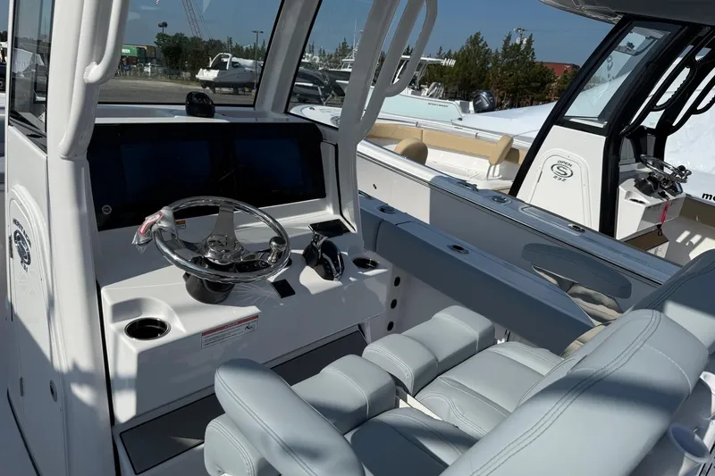 Slide: The Image of 2026 Sportsman Heritage 231 Center Console boat interior with modern helm and seating. - 5