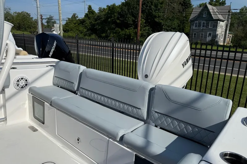 Slide: The Image of 2026 Sportsman Heritage 231 Center Console boat with Yamaha engine and cushioned seating. - 7