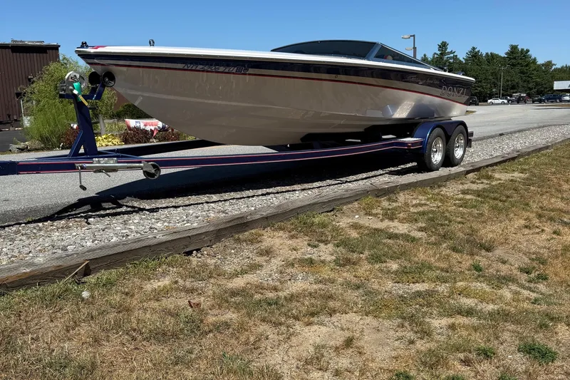 Slide: The Image of 2002 Donzi 22 Classic boat on trailer, parked outdoors on a sunny day. - 14
