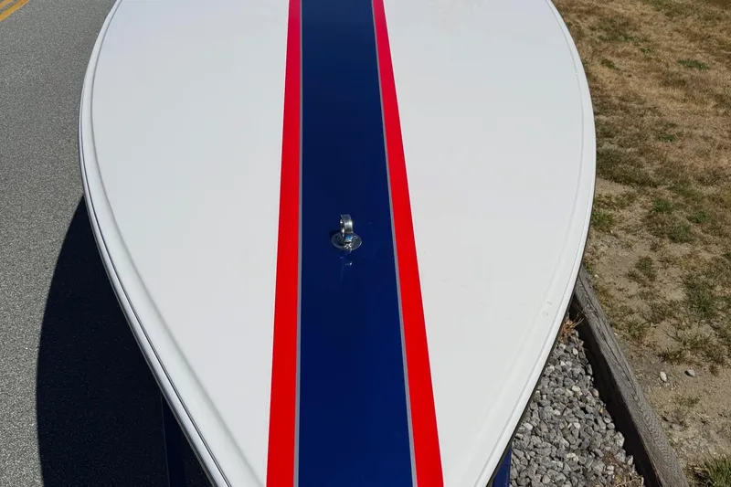 Slide: The Image of 2002 Donzi 22 Classic boat with blue and red stripe on white hull. - 15