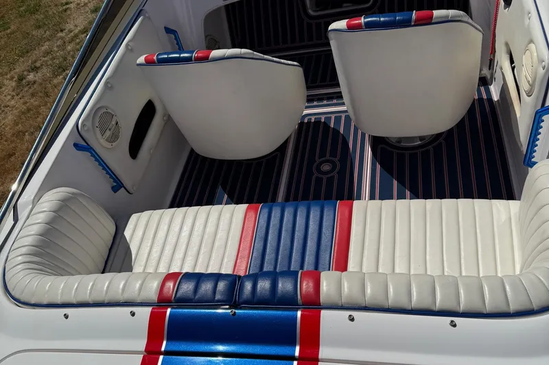 Slide: The Image of 2002 Donzi 22 Classic boat interior with white, red, and blue seating. - 16