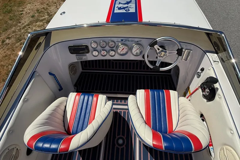 Slide: The Image of 2002 Donzi 22 Classic boat interior with red, white, and blue seats and dashboard. - 6