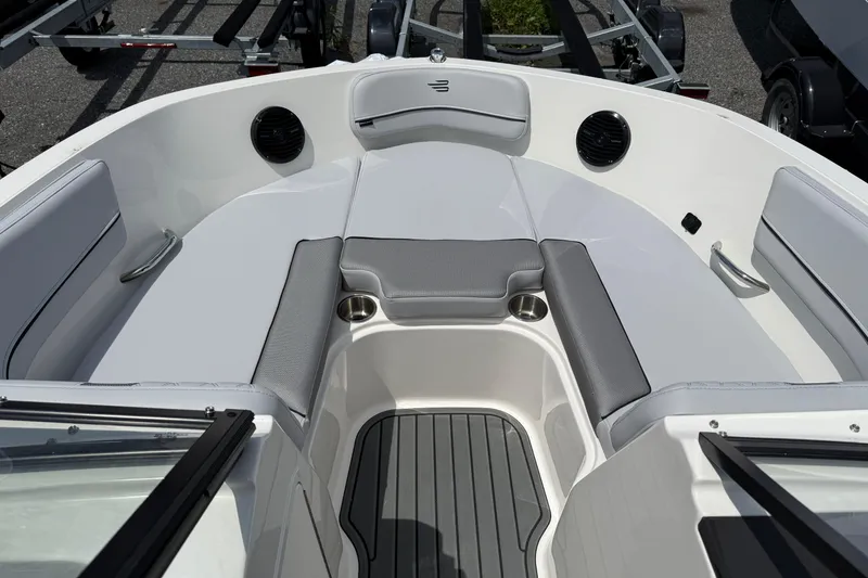 Slide: The Image of 2025 Bayliner VR5 Bowrider I/O interior with gray seating and cup holders. - 11