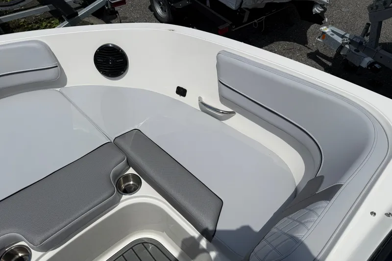 Slide: The Image of 2025 Bayliner VR5 Bowrider I/O interior with cushioned seating and cup holders. - 13