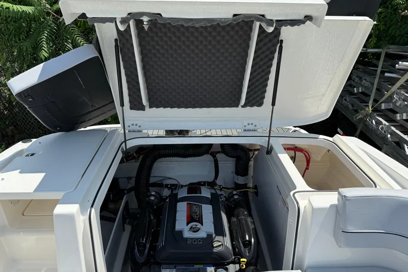 Slide: The Image of 2025 Bayliner VR5 Bowrider I/O engine compartment with open hatch, showcasing the engine. - 15