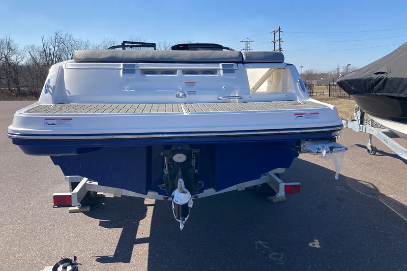 Slide: The Image of 2025 Bayliner VR5 Bowrider I/O boat on trailer, rear view, outdoors. - 3