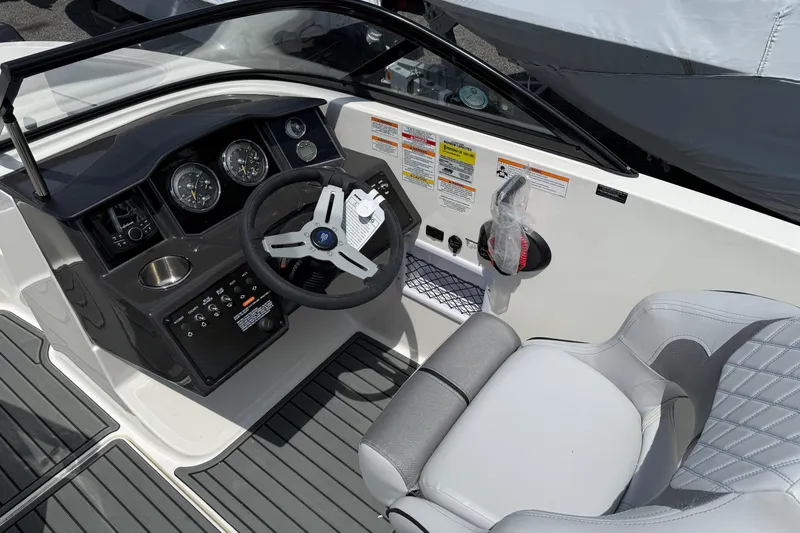 Slide: The Image of 2025 Bayliner VR5 Bowrider I/O cockpit with modern steering and controls. - 9