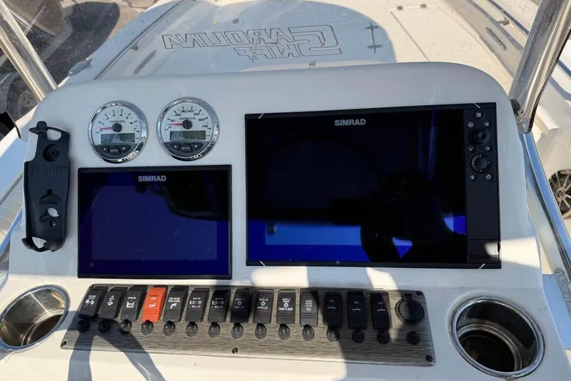 Slide: The Image of Dashboard of a 2018 Carolina Skiff 23LX with Simrad displays and control panel. - 12