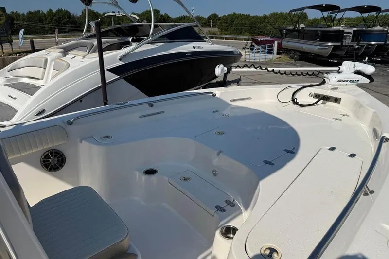 Slide: The Image of 2018 Carolina Skiff 23LX boat deck with seating and storage compartments. - 14
