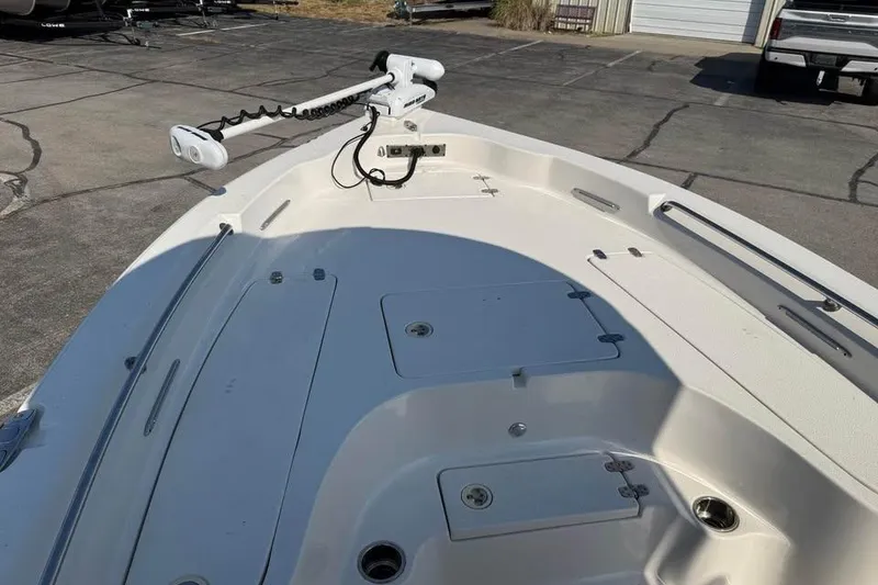 Slide: The Image of 2018 Carolina Skiff 23LX boat deck with trolling motor and storage compartments. - 16