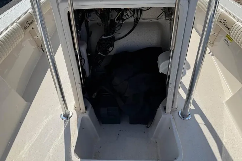 Slide: The Image of 2018 Carolina Skiff 23LX boat storage compartment with wiring and equipment. - 19
