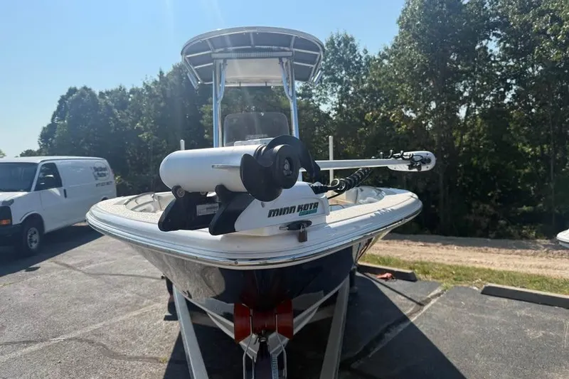 Slide: The Image of 2018 Carolina Skiff 23LX boat with Minn Kota trolling motor, parked outdoors. - 3