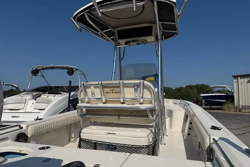 Slide: The Image of 2018 Carolina Skiff 23LX boat with T-top and seating, docked under clear blue sky. - 8