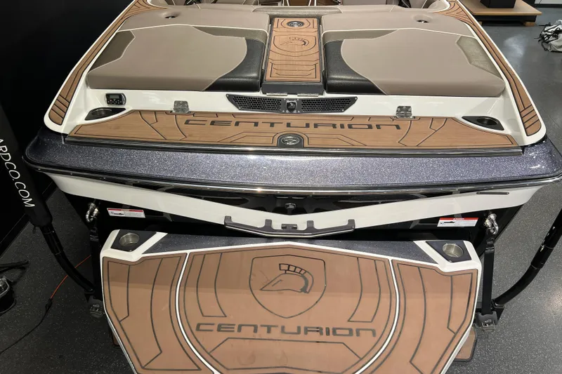 Slide: The Image of 2017 Centurion Ri257 boat with sleek design and wood accents, rear view. - 4