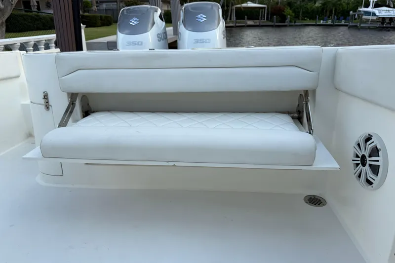 Slide: The Image of 2021 Marlin 39 CC boat with white cushioned seating and dual Suzuki 350 engines. - 10
