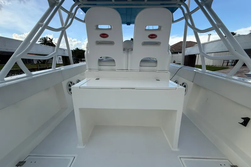 Slide: The Image of 2021 Marlin 39 CC boat interior with dual white seats and sturdy framework. - 13