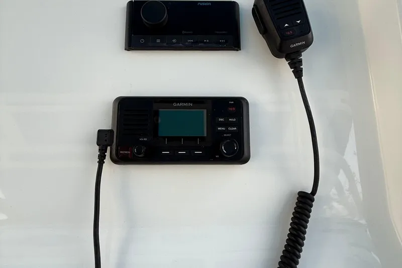 Slide: The Image of 2021 Marlin 39 CC boat dashboard with Garmin marine radio and controls. - 25