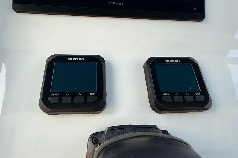 Slide: The Image of Suzuki digital displays on 2021 Marlin 39 CC boat dashboard. - 27