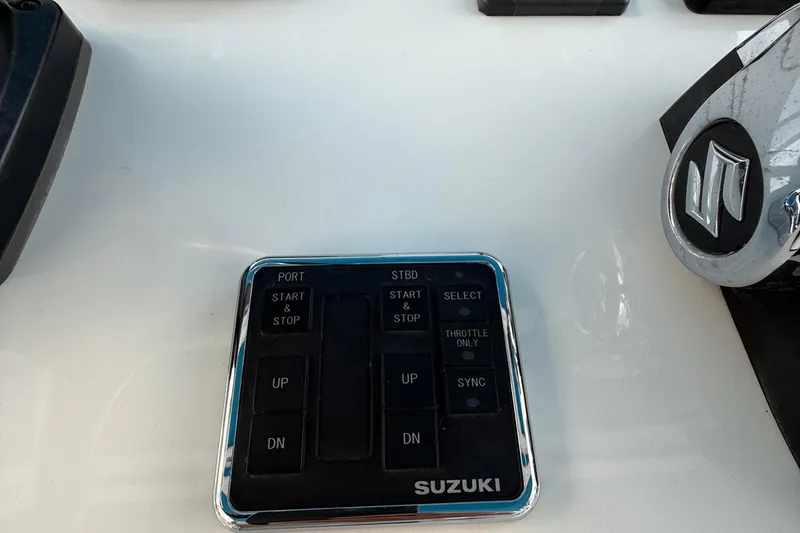 Slide: The Image of Control panel of a 2021 Marlin 39 CC boat with Suzuki branding. - 29
