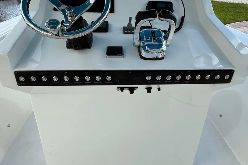 Slide: The Image of 2021 Marlin 39 CC boat console with steering wheel and control panel. - 31