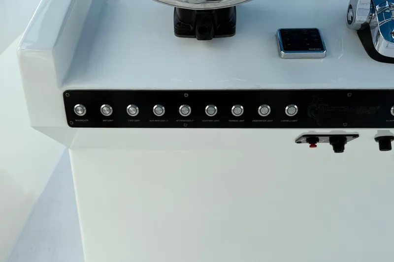 Slide: The Image of Control panel of a 2021 Marlin 39 CC boat with labeled buttons and switches. - 32
