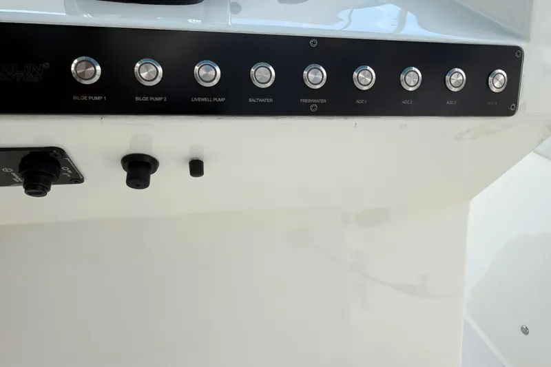 Slide: The Image of Control panel of 2021 Marlin 39 CC boat with labeled buttons and switches. - 35
