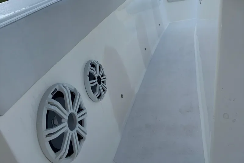 Slide: The Image of 2021 Marlin 39 CC boat interior with built-in speakers on white panel. - 37