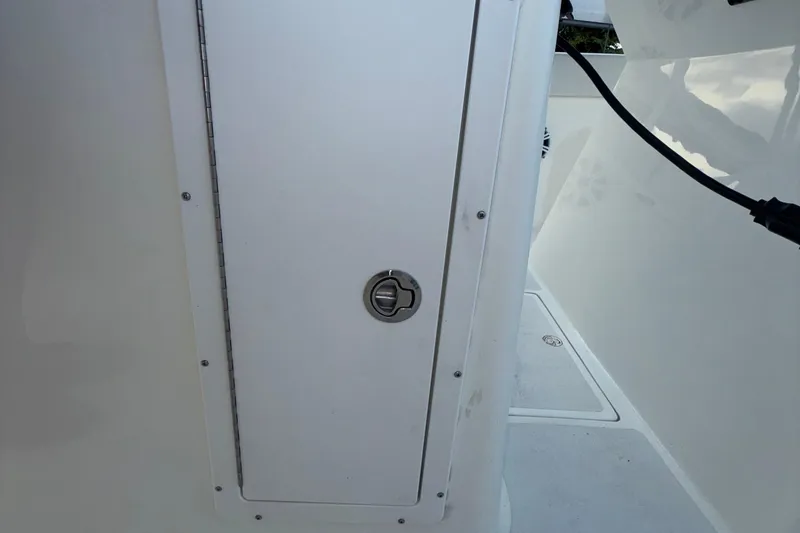 Slide: The Image of 2021 Marlin 39 CC boat interior with a closed storage compartment door. - 40