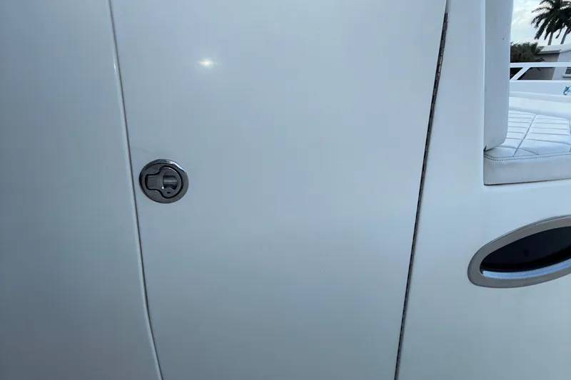 Slide: The Image of 2021 Marlin 39 CC boat door with sleek handle and white finish. - 42